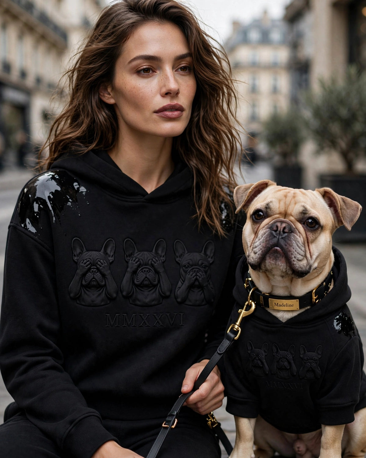 Woman and French Bulldog in matching black hoodies with Three Wise Frenchies embossed graphic